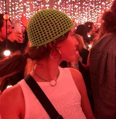 a woman wearing a green crochet hat at a party