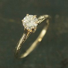 a close up of a ring with a diamond