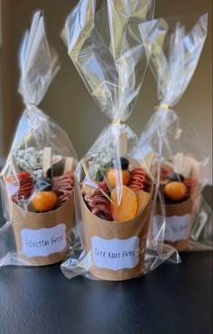 three bags filled with different types of food on top of a table next to each other