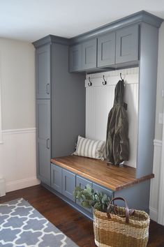 a bench that is in the middle of a room with gray cabinets and benches on it