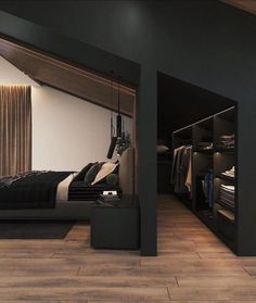 a bedroom with black walls and wooden flooring is shown in this image, there are closets on either side of the bed