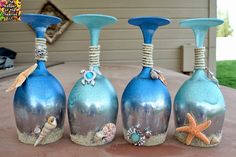 four blue vases with shells and seashells on them