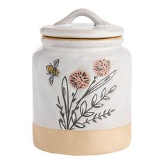 a ceramic jar with flowers and bees on it