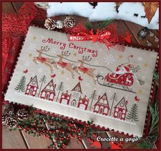 a cross stitch christmas scene with santa's sleigh and reindeer on it