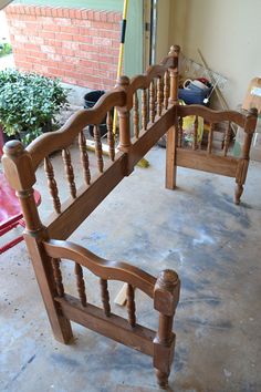 a wooden bed frame sitting on top of a cement floor