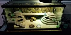 a fish tank filled with different types of rocks and sand in the middle of it