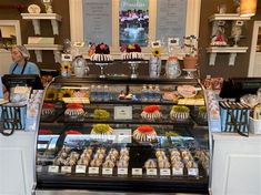 a display case in a bakery filled with cakes and pastries