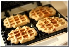 four waffles sitting on top of an electric stove