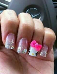 a person with hello kitty nail art on their nails