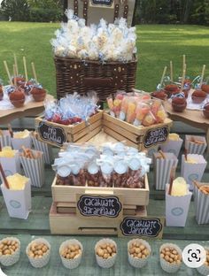 a table topped with lots of desserts and snacks on top of wooden trays