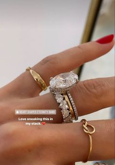 a woman's hand with two different rings on it and the words, i love breaking this in my stack