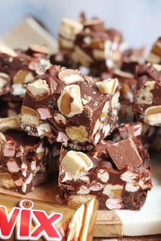 a pile of chocolate and marshmallows sitting on top of a cutting board