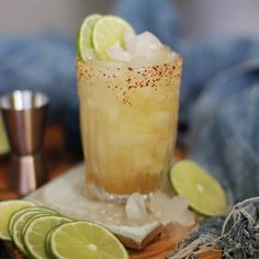 a drink with limes and spices on the table