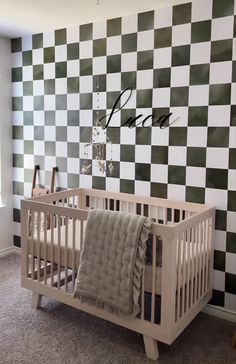 a baby crib in front of a checkered wall