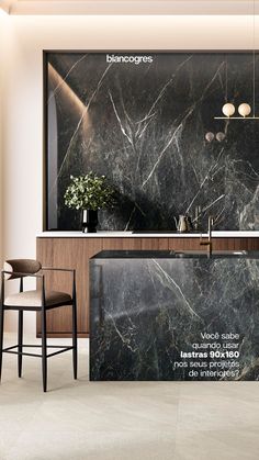 an elegant kitchen with marble counter tops and bar stools