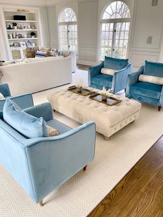 a living room filled with blue and white furniture