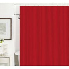 a red shower curtain in a bathroom next to a white toilet and table with flowers on it