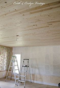 an unfinished room with ladders and wallpaper on the walls in preparation for painting