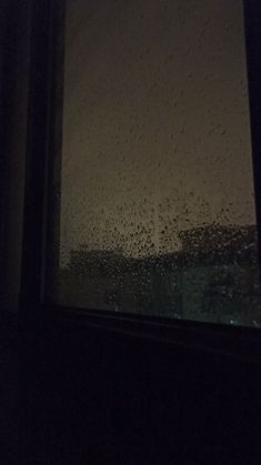 the window is covered in rain and it looks like it could be raining outside or inside