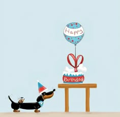 a dachshund dog is looking at a birthday cake with a balloon on it