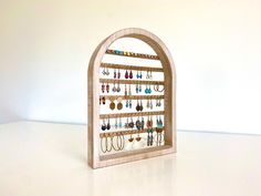 a wooden display with earrings on it