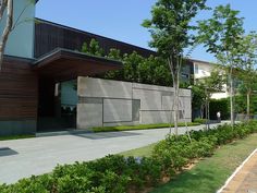 an exterior view of a modern house with trees and shrubs