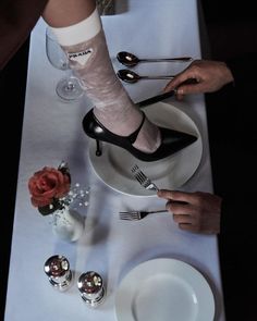 two people with their feet on a plate and one is holding a knife and fork