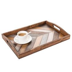 a wooden tray with a cup of coffee and saucer sitting on top of it