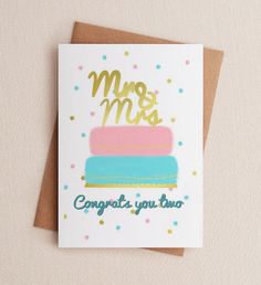 a card that says, mr and mrs congrats you two on top of a cake