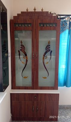 a cabinet with two glass doors on top of it