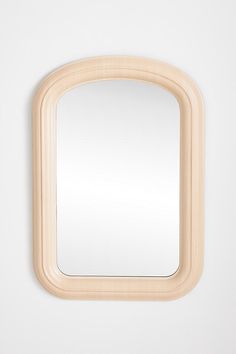 a wooden frame mirror hanging on the wall