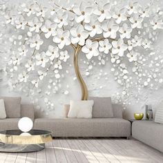 the living room is decorated with white flowers and a large tree on it's wall