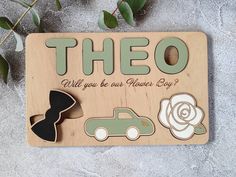 a wooden sign that says,'theo will you be our flower boy? '