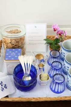 a table topped with blue dishes and cups