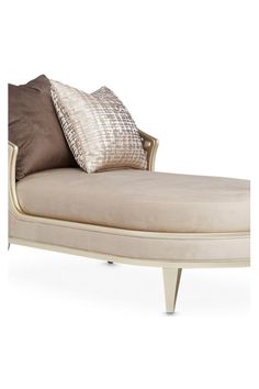 a white chaise lounge chair with two pillows on it's back and side