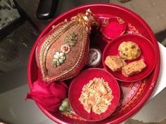 three red bowls filled with food on top of a table