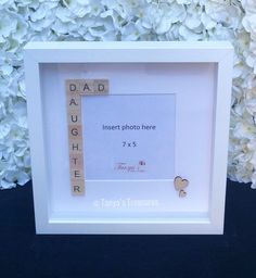 a frame with scrabbles in the shape of hearts and letters that read dad, insert photo here