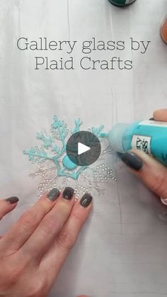 someone is using glue to create a snowflake design on a sheet of paper