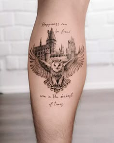 an owl tattoo on the leg with hogwart's castle in the background and harry potter quote