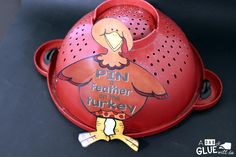 a red pot with a turkey on it's lid that says pin for father of the turkey