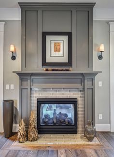 a living room with a fire place next to a painting on the wall above it