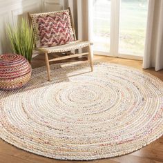 a chair and rug in front of a window