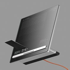 a computer monitor with an orange cord attached to the back of it's display