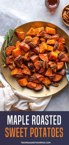 maple roasted sweet potatoes on a platter with rosemary sprigs and pecans