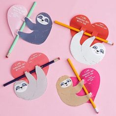 three slotty valentine's day cards with pencils and heart shaped stickers