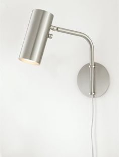 a silver wall light with a white background