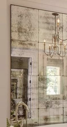 a bathroom with a chandelier hanging from the ceiling next to a bathtub