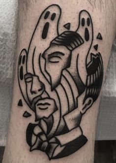 a man's leg with a black and white tattoo design on his arm,