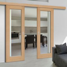 a living room filled with furniture and sliding glass doors that open up to a kitchen