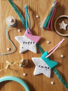 three star ornaments on a wooden table with ribbons and other items around the edges that spell out poppy